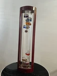 Galileo Thermometer Analog Display Cylindrical Glass Tube Brown Wood Frame. Fixed Price $50.00.